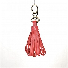 Bijou de sac pompon cuir d'agneau coloris rouge orangé.